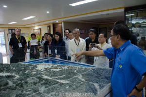 An official of the Philippine Mining Service Corporation shows a prototype of a mining site to the Lao delegates during their visit to Bohol. (Photo credits: CFG) 
