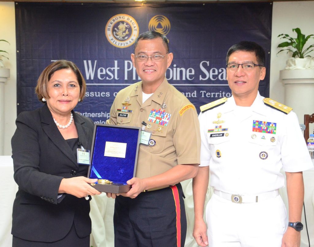 GSPDM Dean Gloria Jumamil-Mercado receives a plaque of appreciation from Maj. Gen. Alexander Balutan, Vice Commander of the Philippine Navy, and Rear Admiral Bayani Gaerlan, Chief of the Philippine Navy's Naval Staff, for helping organize the Maritime Security Symposium.  Mercado stood for President Tony Kalaw in welcoming the participants and provided the synthesis for the activity. (Ped Garcia)  