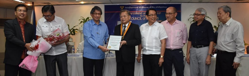 Puno receives his certificate of conferment as member of the DAP Council of Fellows from Kalaw as colleagues that include former Budget Secretary Salvador Enriquez (right) and DAP Executive Fellow Carlos Tabunda Jr. (left) witness.   (Photo by Ped Garcia) 